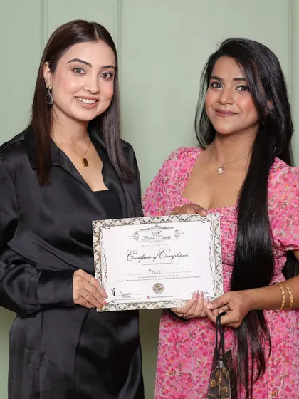 A happy student on her certification day. The one-month journey transforms them into professional makeup artists.