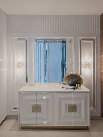 A custom-designed credenza featuring a geometric, fluted pattern on the doors with statement brass hardware. The piece is both a functional storage unit and a work of art, showcasing our expertise in bespoke furniture.