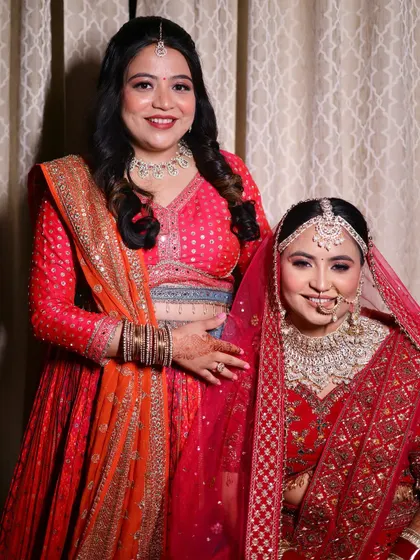 The bride with her sister, both with complementary makeup looks.