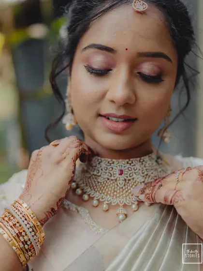 A duplicate of 232, focusing on the bride's gentle touch as she adjusts her necklace.