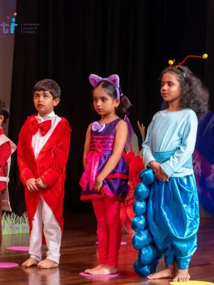 Characters from "Alice in Wonderland" stand on stage. Our annual productions involve every child and are a testament to their hard work and creativity.