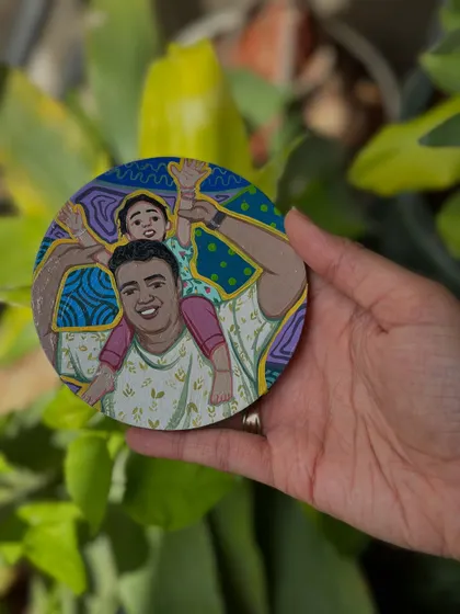 A custom coaster for Father's Day, showing a dad giving his child a piggyback ride.