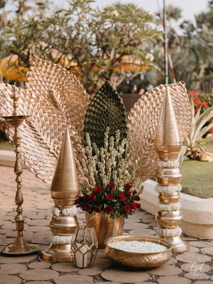 Another traditional decor vignette, featuring a brass lamp (diya) and floral arrangements.
