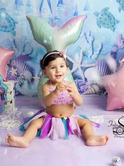 Another angle of this delightful mermaid-themed setup. The combination of colors and props creates a vibrant and joyful scene perfect for a first birthday.