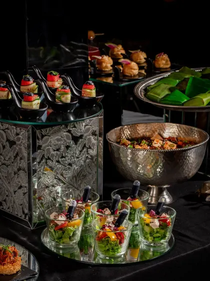 An elegant setup for a Diwali house party. We provide full-service catering with sophisticated serveware and a menu of gourmet bites to elevate your celebration.