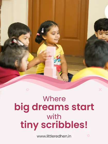 A young girl proudly builds a tower of pink blocks, her face beaming with accomplishment. We believe big dreams start with tiny scribbles and playful creations.
