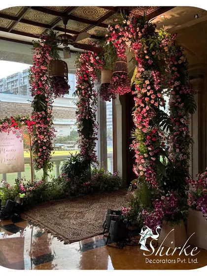 An enchanted garden entrance we crafted to welcome guests. The design features dense arches of pink and white flowers, creating a lush, immersive floral tunnel that sets a magical tone for the celebration right from the start.
