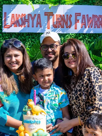 The birthday boy and his family celebrating the cake-cutting moment.