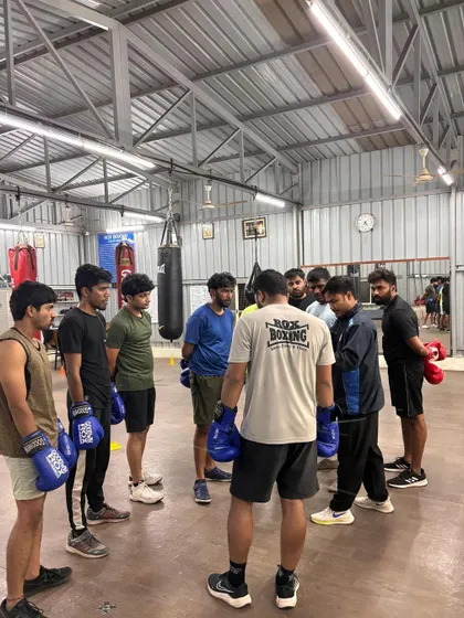 A trainer briefing the group in a huddle before the session begins. We always start with a clear plan.
