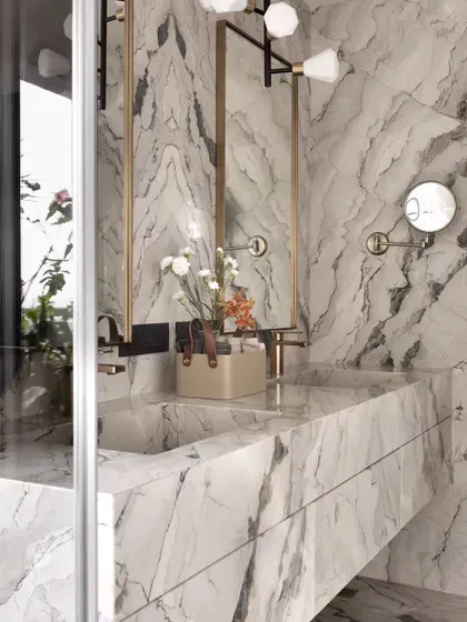 A close-up of the custom-integrated marble sink, a detail that exemplifies understated luxury.
