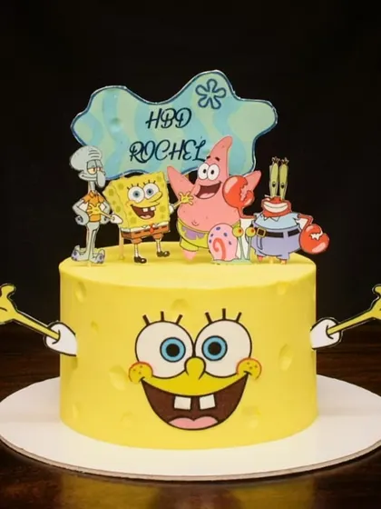 Who lives in a pineapple under the sea? This Spongebob Squarepants cake brings back all the 90s nostalgia, featuring Spongebob's cheerful face and all his friends from Bikini Bottom as edible toppers.