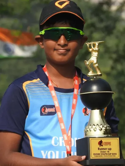 A confident young player with his award. Participating in tournaments builds confidence that goes beyond the cricket field.