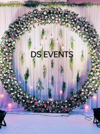 This elegant circular floral arch creates a sophisticated and dreamy backdrop. It's perfect for engagements, anniversaries, or any celebration where you want a touch of modern romance. The hanging leaves and soft lighting add depth and magic.