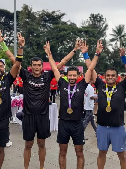 Arms up in victory! The team celebrating their strong performances and the supportive community that helped them get there.