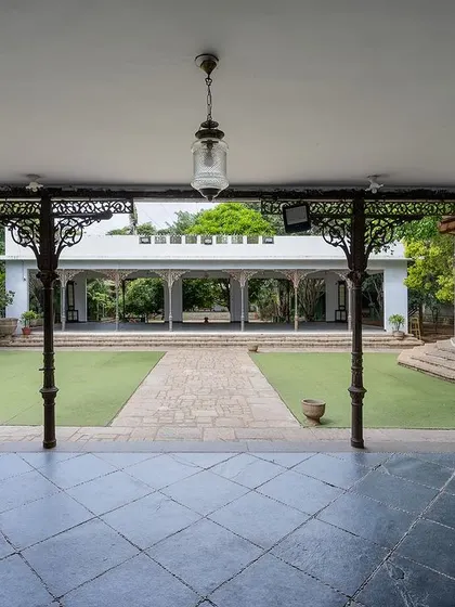 A view of the grand lawn and our colonial bandstand, framed by antique pillars. This open space is perfect for large ceremonies, offering a sense of scale and history.