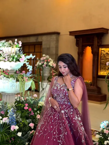 A moment of quiet elegance. This wine-colored ball gown features delicate, branch-like embroidery, making it a unique and romantic choice for an engagement or reception.