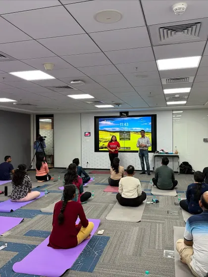 Using the office's existing technology, I can guide both in-person and remote employees simultaneously. Here, I am leading a hybrid session at Manhattan Associates to ensure everyone can participate.