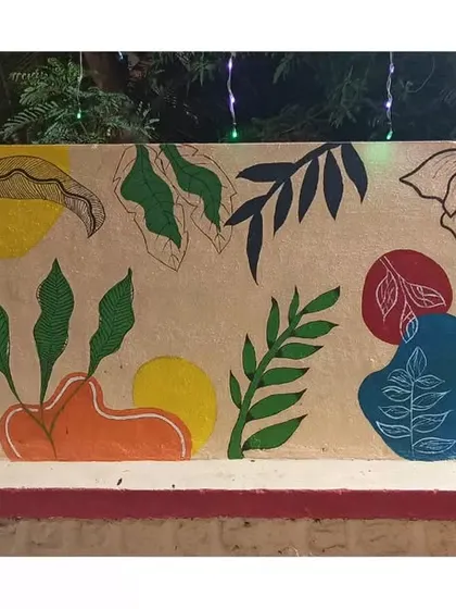 This long wall features an abstract design combining organic leaf shapes with bold, colourful blocks. It's a modern take on a botanical theme.