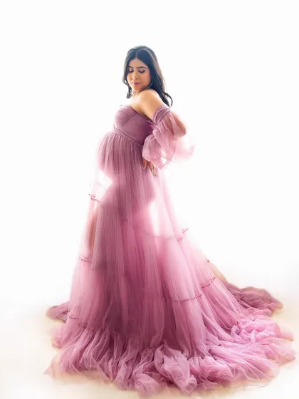 A soft and dreamy pose with a sheer, flowing gown. The way the light shines through the fabric creates an ethereal and artistic look.