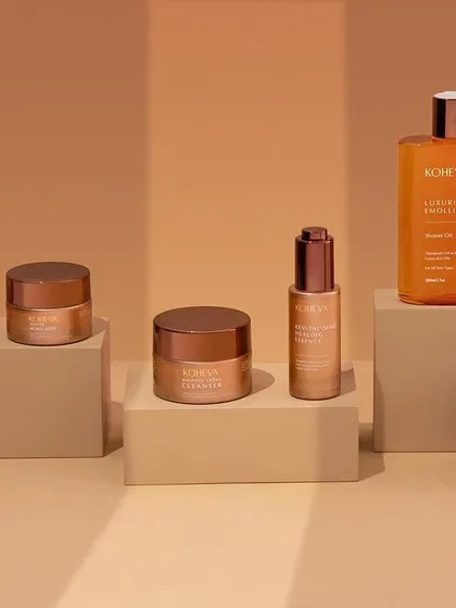 A minimalist arrangement of Koheva's skincare line. The clean composition and parallel shadows create a sophisticated and modern look that highlights the elegant packaging.