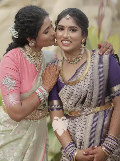 A sweet moment between the sisters, showcasing their elegant blouses.