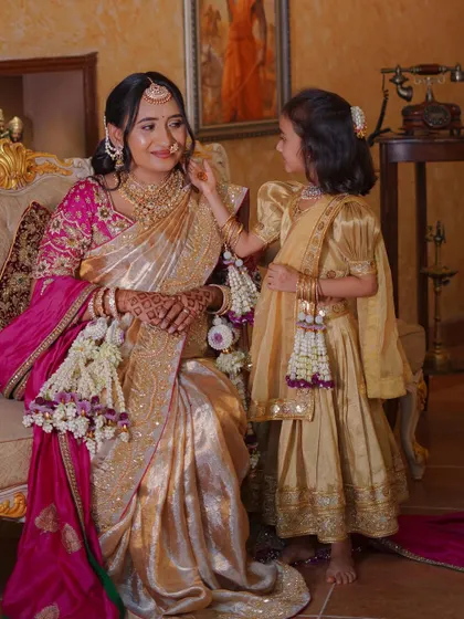 An adorable moment where the daughter helps her mother get ready. Both are wearing our custom floral accessories for the baby shower.