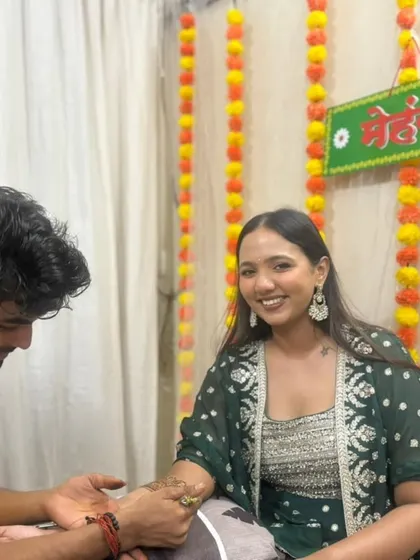A candid shot of me working while the bride smiles for the camera. I offer free home service all over Mumbai.