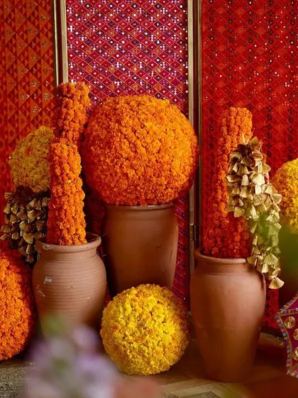 Another angle of the marigold and terracotta decor, highlighting the rich textures and vibrant colors that bring the Phulkari theme to life.