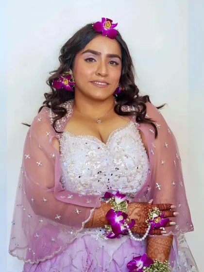 A full-length view of this fresh and pretty look. The soft makeup is perfect for a daytime event and complements her pastel outfit beautifully.