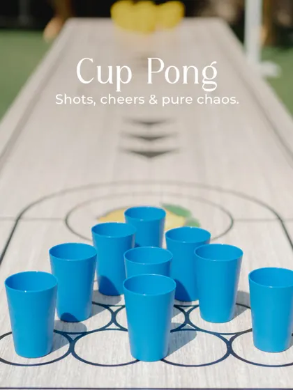 A cup pong table set up for guests to enjoy. Games like this are a simple way to ensure people are mingling, laughing, and having a great time.