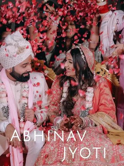 A joyous moment as the couple is showered with rose petals by their loved ones after the ceremony.
