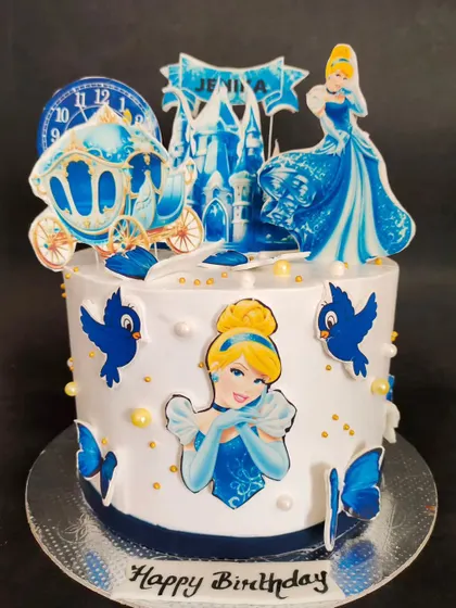 A magical Cinderella theme cake for a lovely princess. This chocolate roasted almond cake features edible prints of the classic Disney character and her carriage.