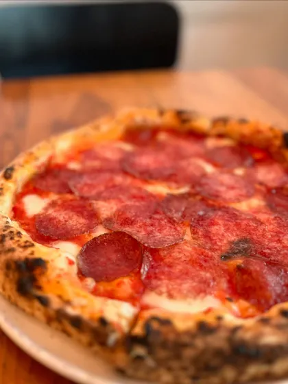 A close-up of the Hungarian Salami pizza, showcasing its rich, savory topping.