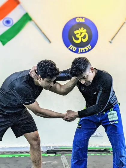Learn, grow, become. Two students are engaged in a wrestling clinch, fighting for position and control. This is the essence of grappling: a physical battle of wills and technique.