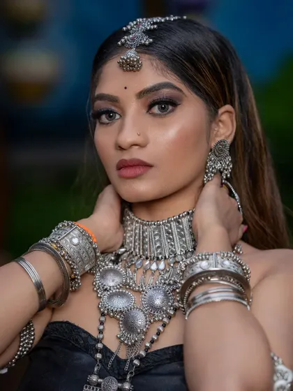 A close-up portrait showcasing the beautiful eye makeup that complements the heavy silver jewelry. My students learn to balance bold elements perfectly.