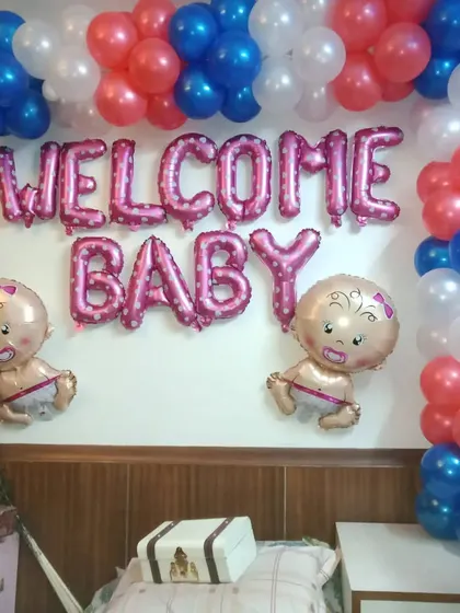 A classic "Welcome Baby" wall decoration. I use pink foil letter balloons, baby-shaped foil balloons, and a simple balloon arch in red, white, and blue for a cheerful and direct welcome message.