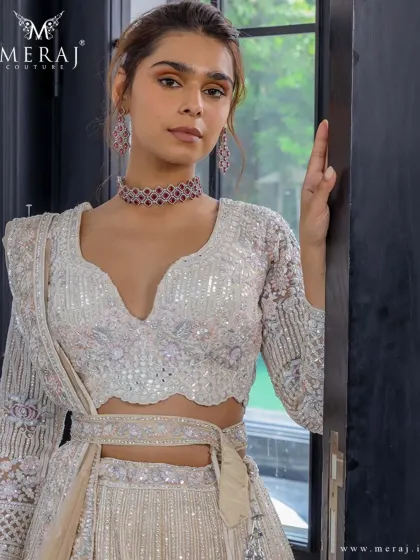 Soft hues and bold details define this elegant lehenga from the 'Ruvaah' collection, featuring finely detailed floral embroidery and shimmering sequin work.