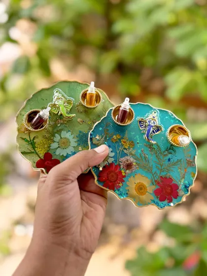 Add a pop of elegance to your celebrations with these handcrafted puja thalis, shown here in green and blue with preserved flowers.