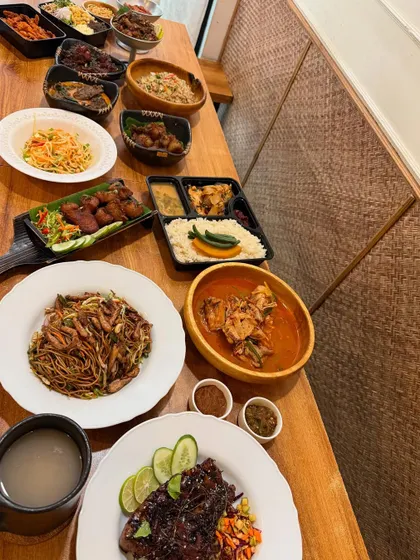 A New Year's feast spread across the table at Naga Belly. We love starting the year by sharing an abundance of good food with our community.