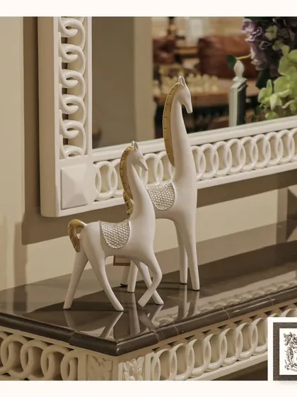 This serene pair of white and gold horse sculptures adds a touch of modern elegance. The clean lines and subtle sparkle make them a sophisticated accent for a contemporary console table.