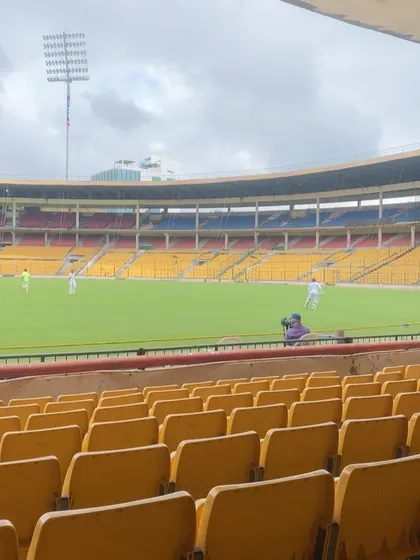 The view from the stands at the M. Chinnaswamy Stadium during a Ranji Trophy match. This is the stage our players work towards, and we are proud to see them make their debut here.