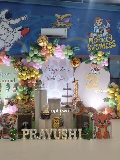 The full setup for Prayushi's "Wild Two" party, showing the unique backdrop of the venue.
