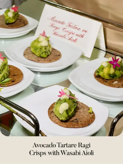 Avocado Tartare on Ragi Crisps with a kick of Wasabi Aioli. The menu card in the background highlights the dish for guests.