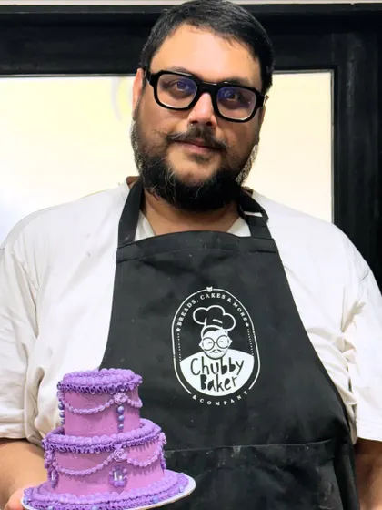 Here I am with a mini version of a tiered vintage cake I made for a client's celebration. I love connecting with my customers and being a small part of their big moments. This is what it's all about: making an impact, one delicious and beautiful cake at a time.