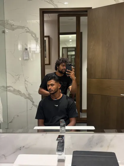 A mirror selfie during a haircut for Sai Sudharsan, capturing the process.