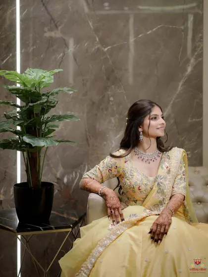 A poised and elegant shot of the bride-to-be. Her makeup in this yellow lehenga is soft yet defined, with a focus on a smooth, radiant complexion that looks incredible both on and off camera.