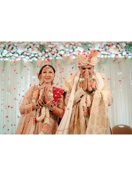 With hands joined in respect and gratitude, the couple thanks their guests. This is a moment of humility and grace that we love to capture.