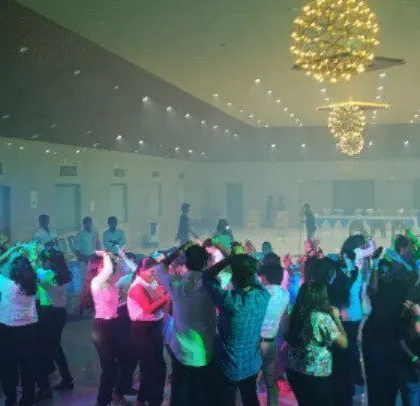 A full dance floor at a corporate event, showing how I keep the energy going all night.