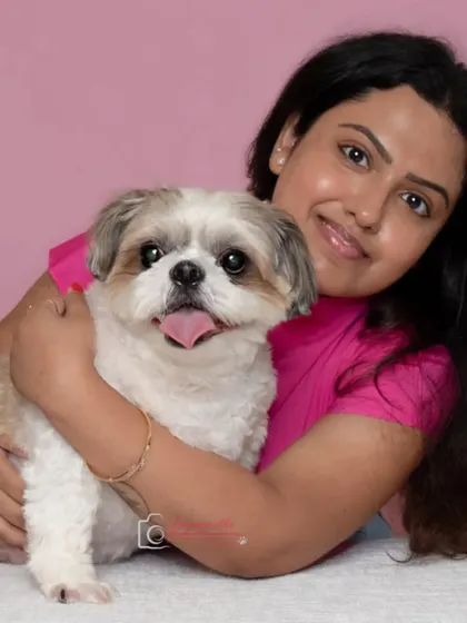 A sweet studio portrait of a girl and her Shih Tzu, capturing the playful and loving bond they share.