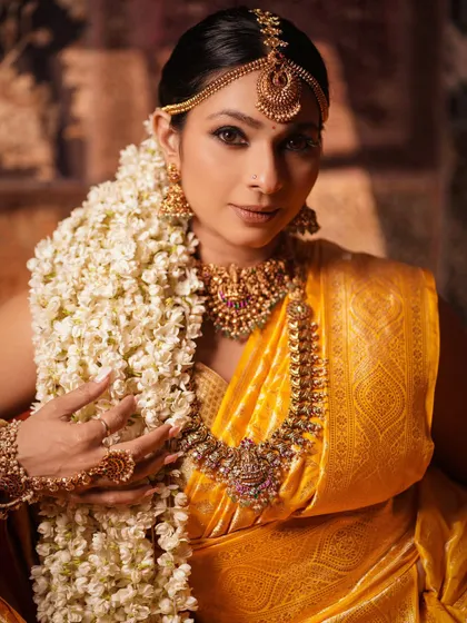 A close-up of Tanishaa Mukerji, focusing on the magnificent temple jewelry. This shot details the craftsmanship of the necklace, earrings, and matha patti, central to the divine look.